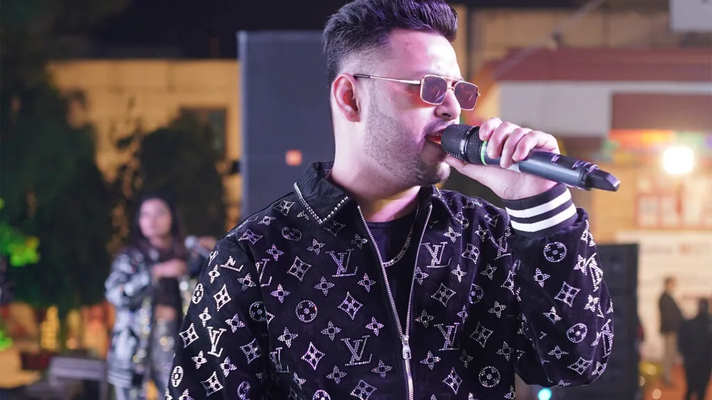 Tushar Negi performing with Mashupminati and Mashupmantra DJ-based bands at a live music event, showcasing his journey from background dancer to DJ-based band founder.